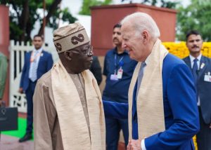 President Joe Biden in a Suit and President Bola Ahmed TInubu in Native Attire exchanging plesantries